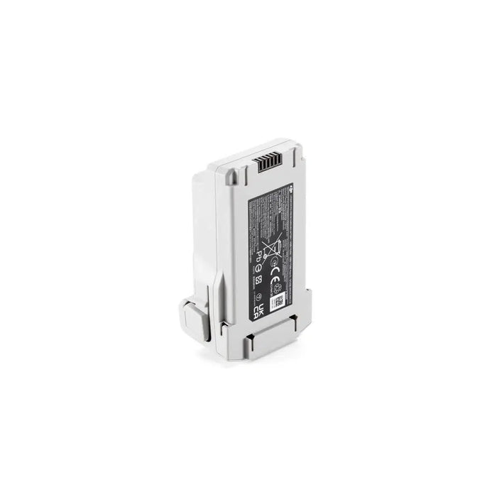 Small electronic device with a metallic finish on a white background