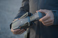 Person holding a portable electronic device with a blurred background