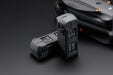 Two drone batteries on a dark background