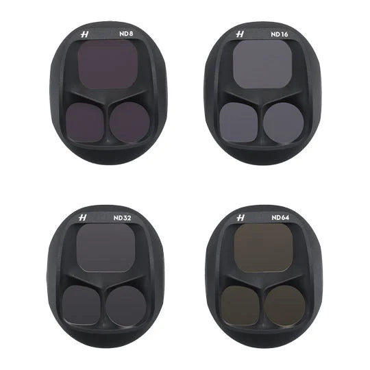 Four camera lens filters with different ND values on a white background