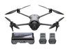 Black drone with propellers, a control device, and two batteries on a white background