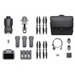 Collection of drone parts and accessories including propellers, battery, remote control, and carrying case on a white background.