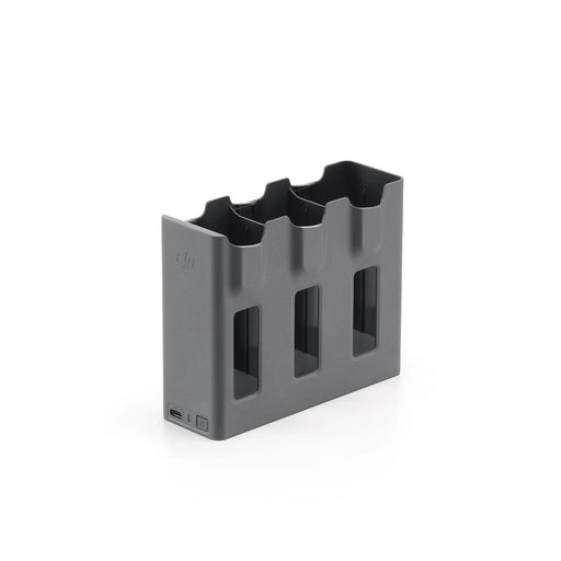 Gray battery charger with multiple slots on a white background