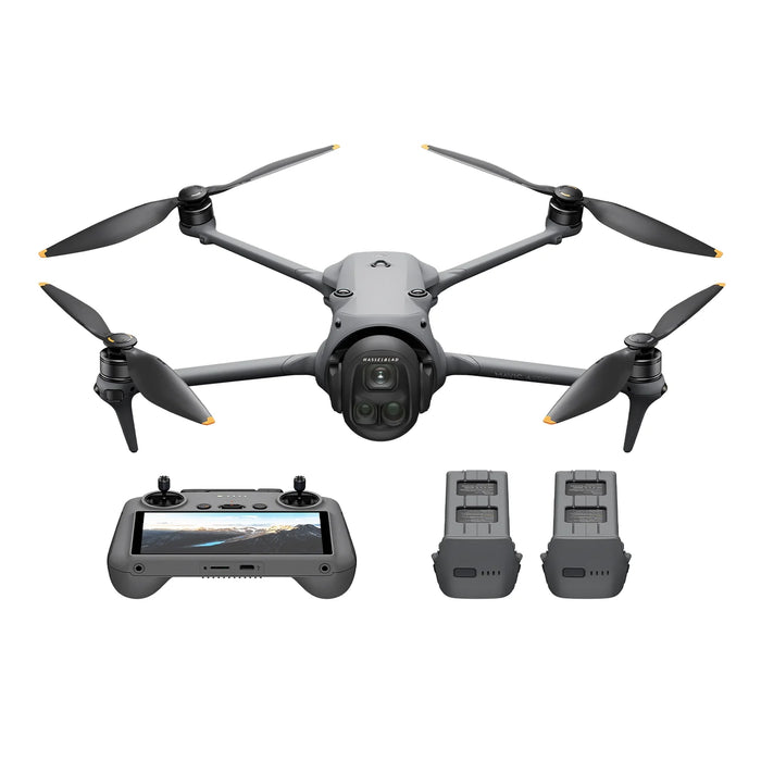 Drone with propellers, remote control, and batteries on a white background