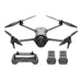 Drone with propellers, remote control, and batteries on a white background